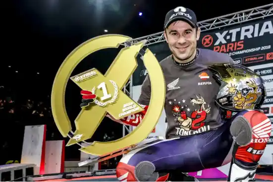 Piloto de X-Trial sosteniendo el trofeo de campeón del mundo 2018
